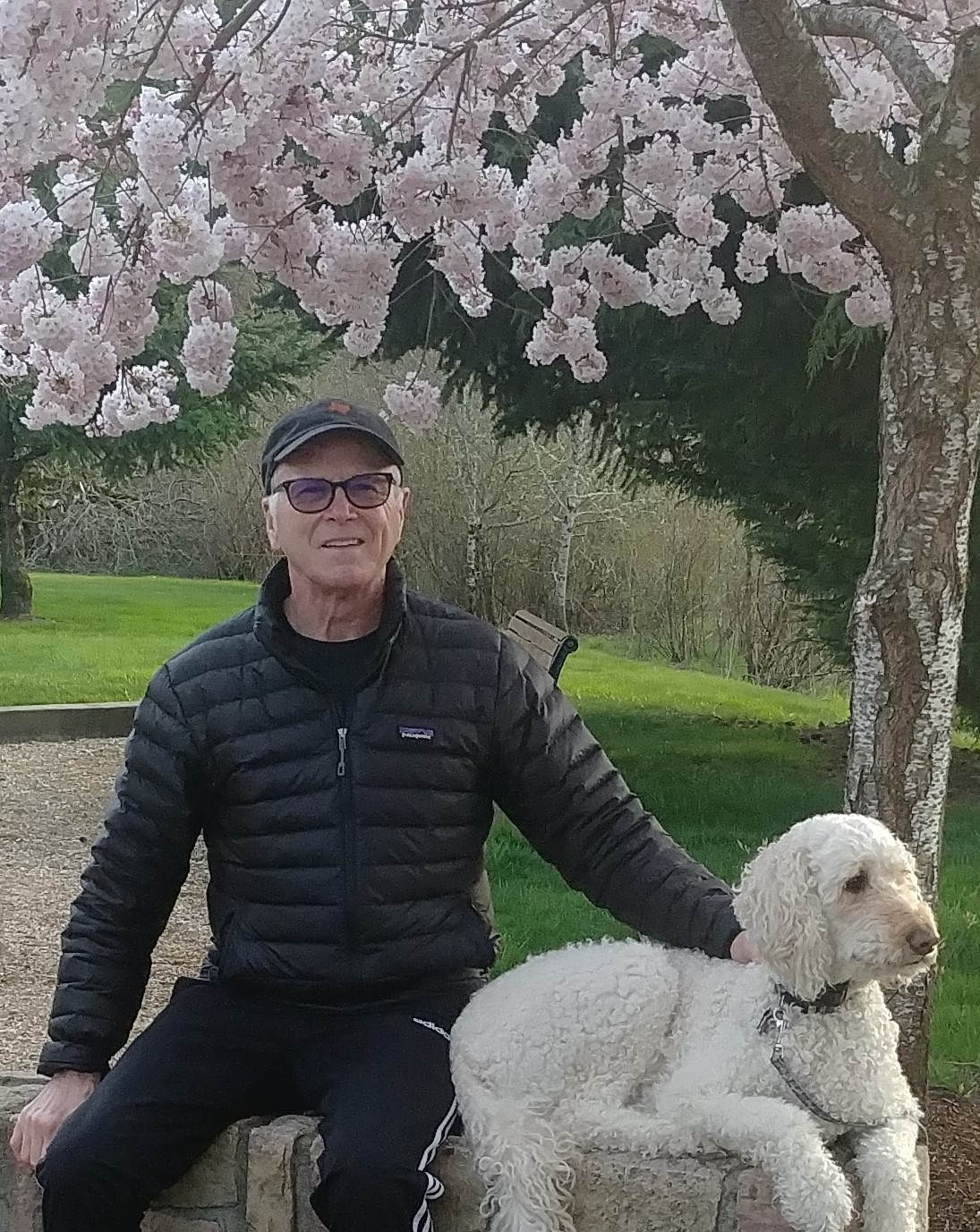 Bill with his dog Shasta, under cherry blossoms in April 2021