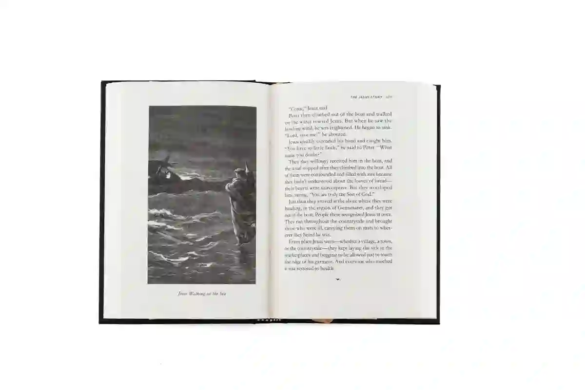 An interior page of The Jesus Story, opened to the engraved illustration 'Jesus Walking on the Sea' beside the Gospel text.