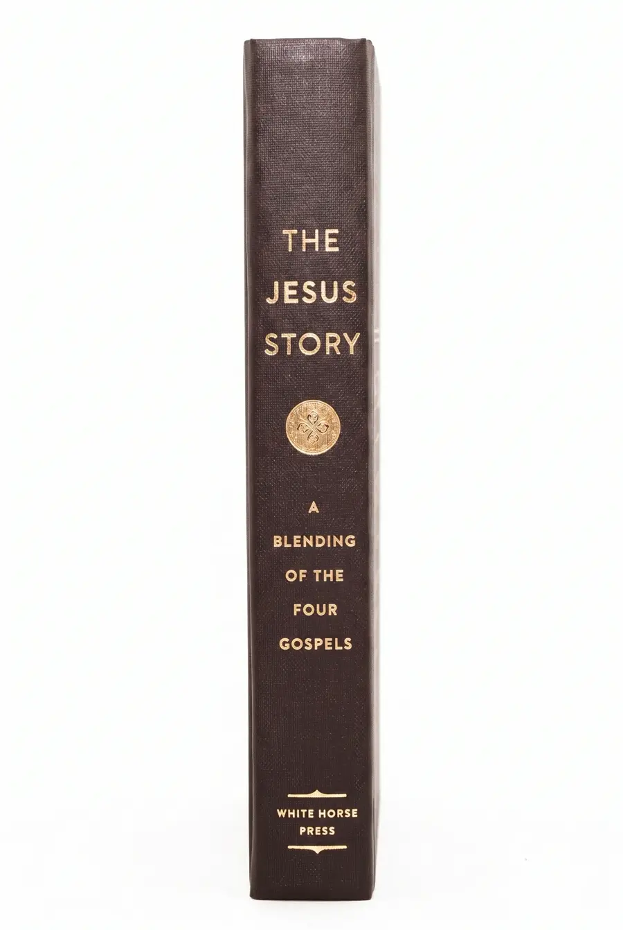 The Jesus Story — hardcover photographed standing on a shelf, bronze spine with gold-leaf title.